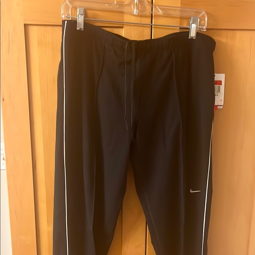 Women’s Nike Black running pants with leg zip.  Size L.
